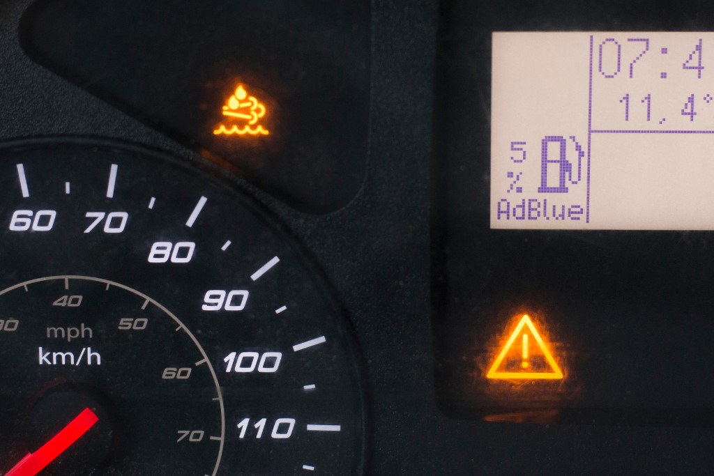 close up of car dashboard with warning signals and adblue error