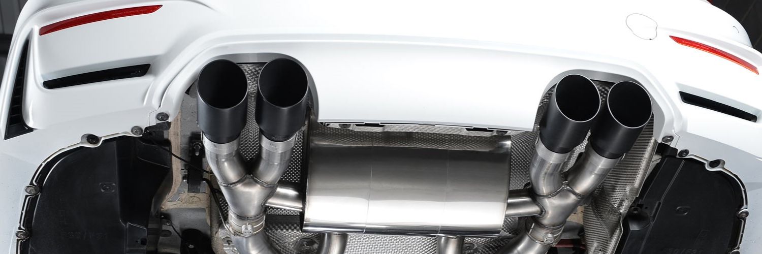 image of two pairs of sport exhausts under a white car