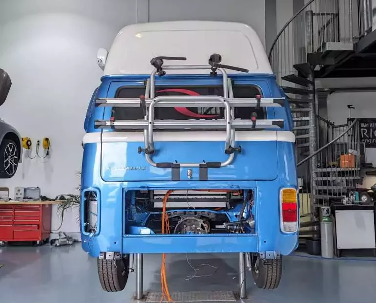 a blue volkswagen van in a garage