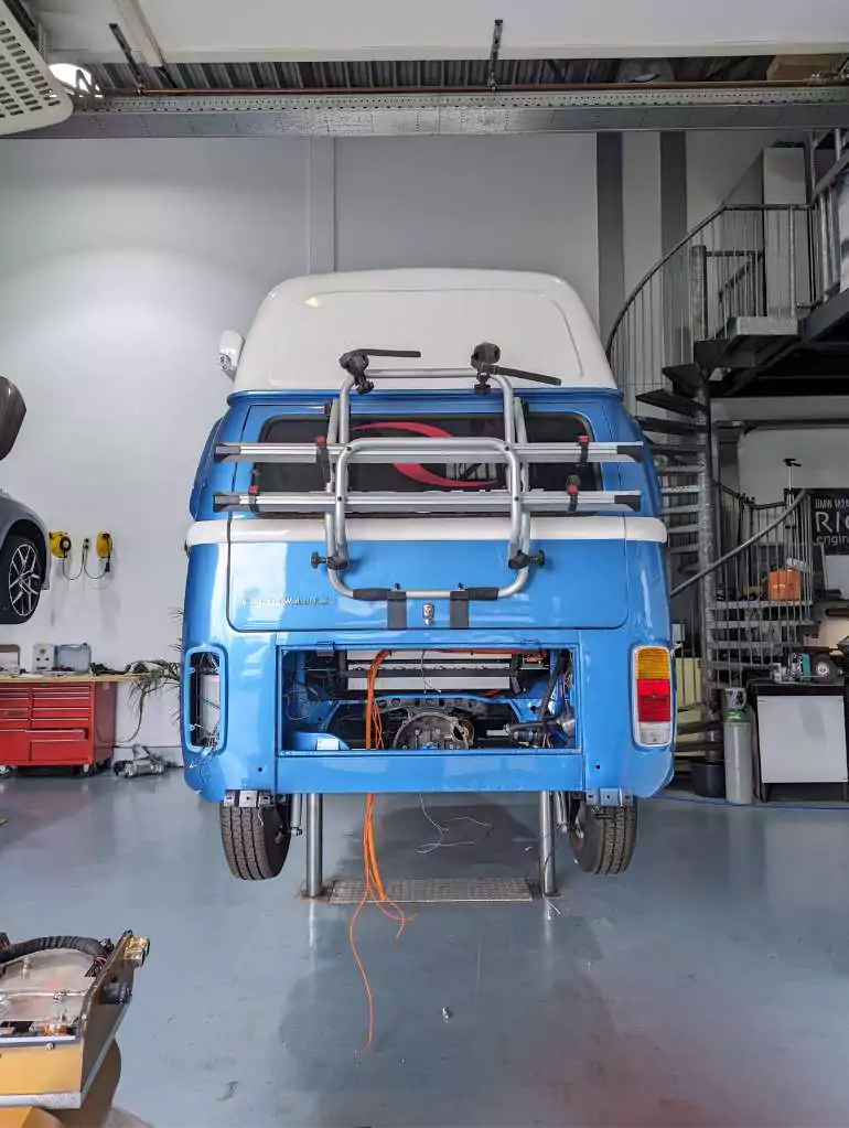 a blue volkswagen van in a garage