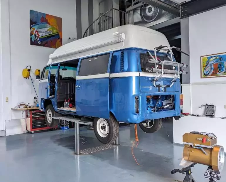 a blue volkswagen van in a garage