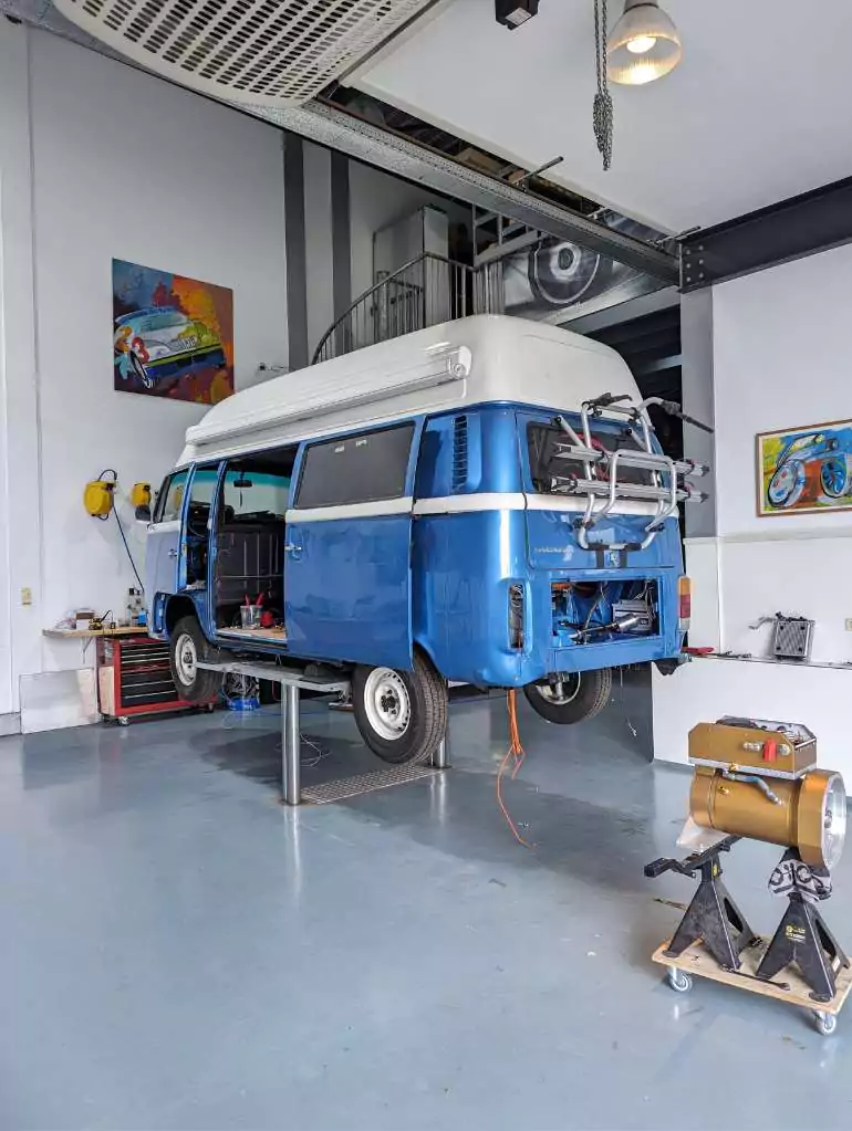 a blue volkswagen van in a garage