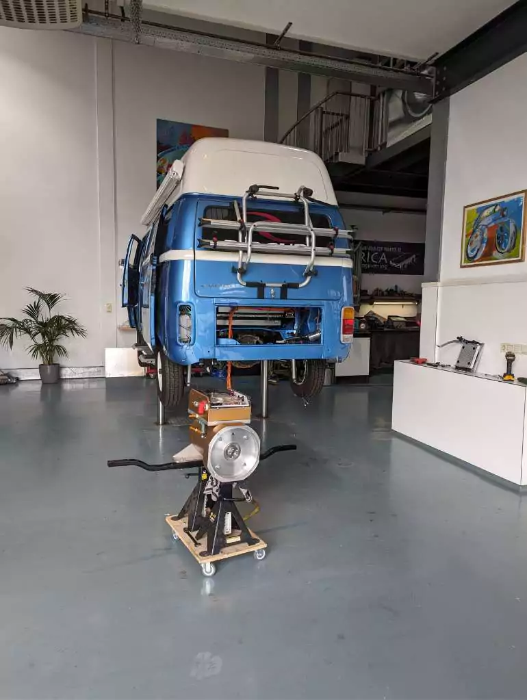 a blue volkswagen van in a garage