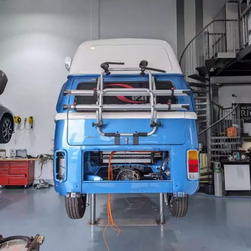 a blue volkswagen van in a garage