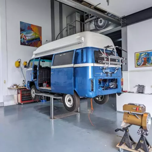 a blue volkswagen van in a garage